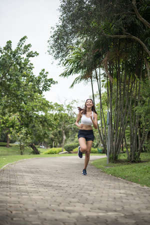 Young beautiful sport woman running at the park. Health and sport concept.の写真素材