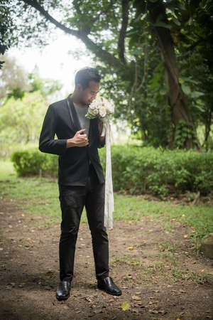Beautiful bouquet in the hands of the groom for bride.の写真素材