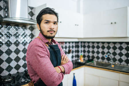 Handsome man preparing stuff for cooking at home.の写真素材