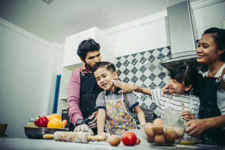 Happy family have a good time cooking together in the kitchen at home. Family concept.の写真素材