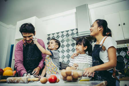 Happy family have a good time cooking together in the kitchen at home. Family concept.の写真素材