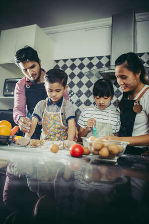 Happy family have a good time cooking together in the kitchen at home. Family concept.の写真素材