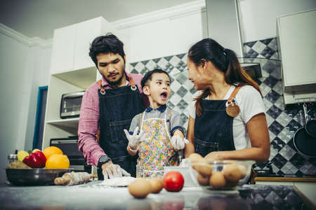 Happy family have a good time cooking together in the kitchen at home. Family concept.の写真素材