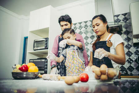 Happy family have a good time cooking together in the kitchen at home. Family concept.の写真素材