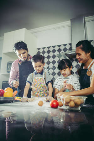 Happy family have a good time cooking together in the kitchen at home. Family concept.の写真素材