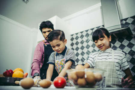 Happy family cooking together in the kitchen at home. Family concept.の写真素材