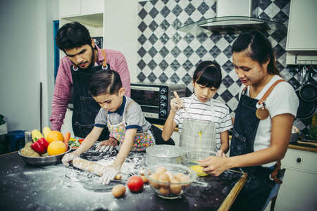 Happy family have a good time cooking together in the kitchen at home. Family concept.の写真素材