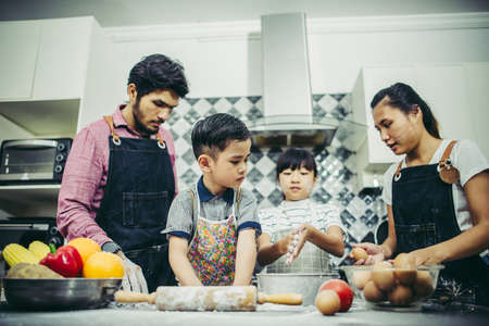 Happy family have a good time cooking together in the kitchen at home. Family concept.の写真素材