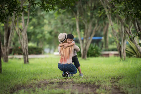 Portrait of mother and son happy cuddle together in the park. Family concept.の写真素材