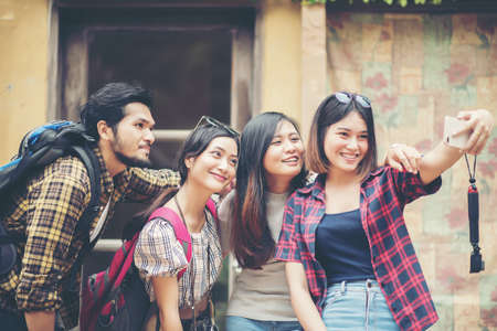 Group of friends taking selfie in a urban street having good fun together.の写真素材