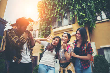 Group of happy friends taking selfies together in urban. Friends group enjoy trip holiday having fun.の写真素材