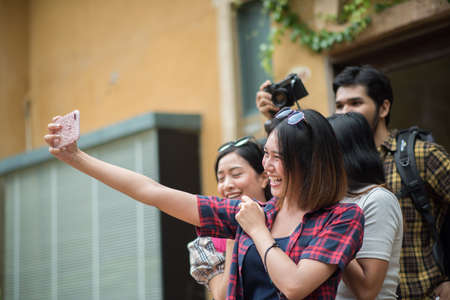 Group of friends taking selfie in a urban street having good fun together.の写真素材