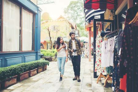 Happy couple walking in urban ,Young adults tourists on travel urban walking together. Couple travel concept.の写真素材