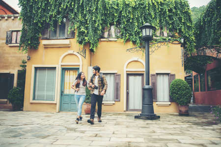 Happy couple walking in urban ,Young adults tourists on travel urban walking together. Couple travel concept.の写真素材