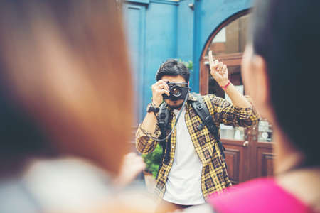 Young man taking selfie of his friends while traveling in urban together.の写真素材