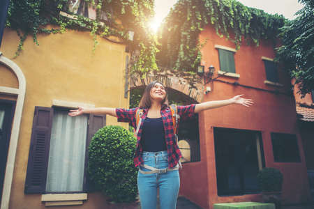 Happy young woman enjoy travel raising her hands in urban. Woman lifestyle concept.の写真素材