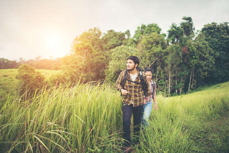 Portrait of happy young couple walking having fun on their hiking trip. Couple concept.の写真素材