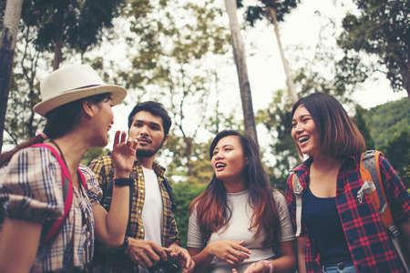 Group of friends having fun talking together while traveling in urban.の写真素材