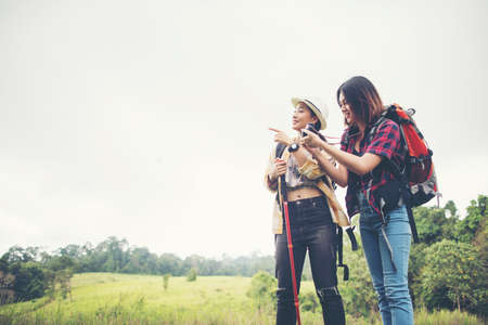 Two of hiking woman standing taking photo have resting after hike to the mountain.の写真素材