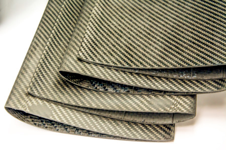 Black carbon fiber composite raw material close up backgroundの写真素材