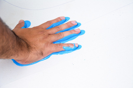 Hand make a trace colorful symbol on white paper backgroundの写真素材