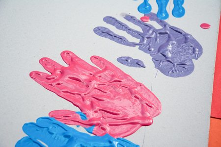 Hand make a trace colorful symbol on white paper backgroundの写真素材