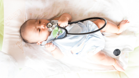 Baby patient have check fever with stethoscope in hospitalの写真素材
