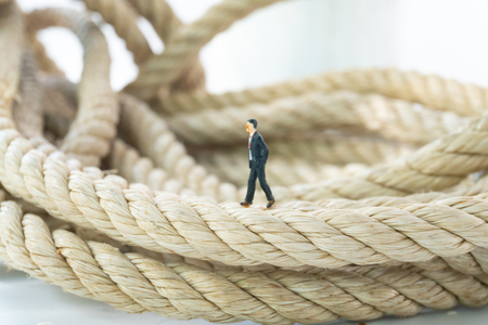 businessman walking on the long rope close upの写真素材