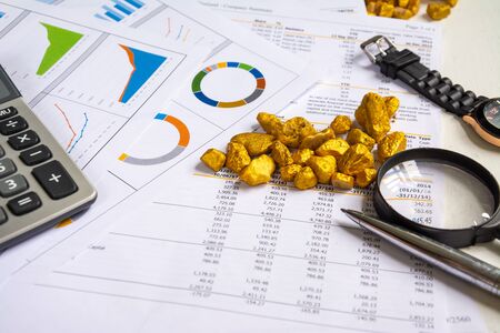 investment concept with graph and account book and  gold stone accessoriesの写真素材