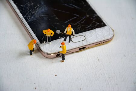 figurine model repair mobile crash with repairmanの写真素材