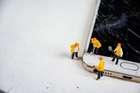 figurine model repair mobile crash with repairmanの写真素材
