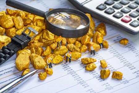 investment concept with graph and account book and  gold stone accessories