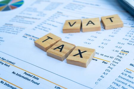tax and vat keyword on wood block in the money wallet with finance paper