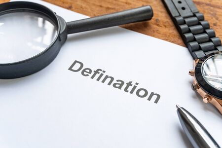 definition text focus word on white paper and pen background