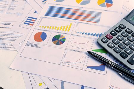 business report with pen statement with graph and data analysis