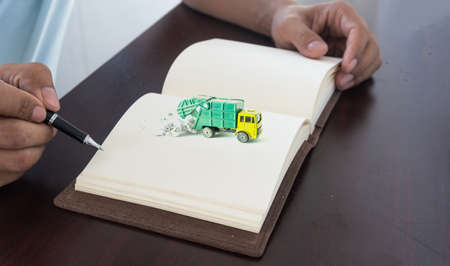 Hand holding a pen for sign business document notebookの写真素材