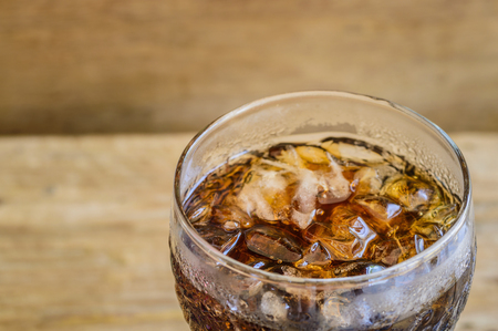 close up cola on the wooden floorの写真素材