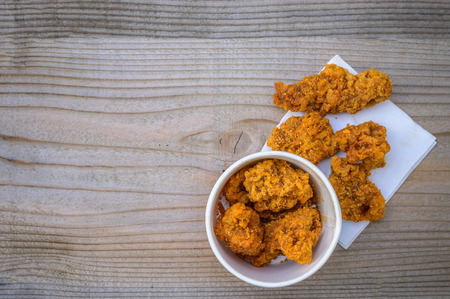 Fried chicken on a wooden floor.の写真素材