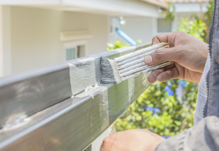 Hand with paintbrush painting a steel.の写真素材