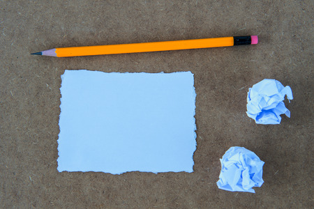 Paper and pencil on wooden background.の写真素材