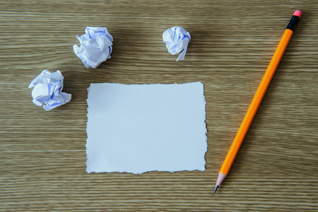 Paper and pencil on wooden background.の写真素材