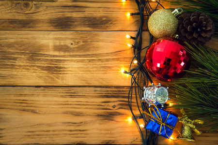 Christmas background with christmas gift,red balls, pine cones on Wooden Background. Christmas vintage styleの写真素材