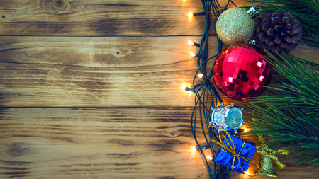 Christmas background with christmas gift,red balls, pine cones on Wooden Background. Christmas vintage styleの写真素材