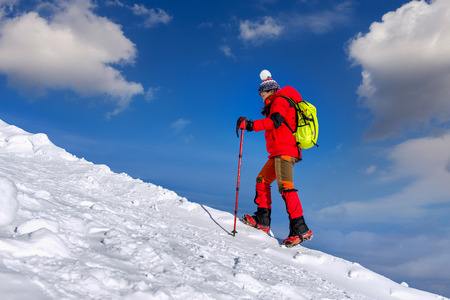 Young woman hiking on high mountains in winter.の写真素材