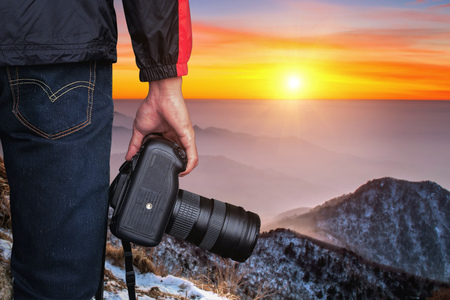 professional photographer with camera at sunset.の写真素材