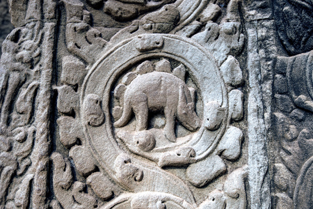 sculpted stone depicting a dinosaur at the ancient Ta Prohm temple at Angkor Wat, Siem Reap, Cambodia.の写真素材