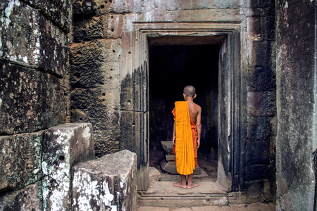 The monks in the ancient stone faces of Bayon temple, Angkor Wat, Siam Reap, Cambodiaの写真素材