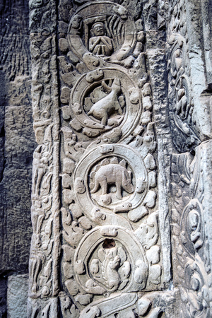 sculpted stone depicting a dinosaur at the ancient Ta Prohm temple at Angkor Wat, Siem Reap, Cambodia.の写真素材