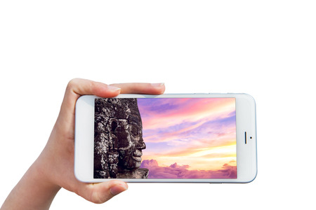 Hand holding Smartphone with image of Angkor Wat Temple, Siem reap in Cambodia.の写真素材