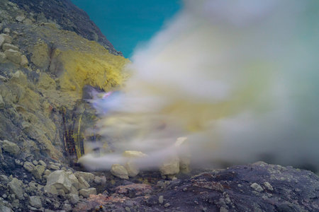 Blue sulfur flames and Sulfur fumes from the crater of Kawah Ijen Volcano in Indonesia.の写真素材